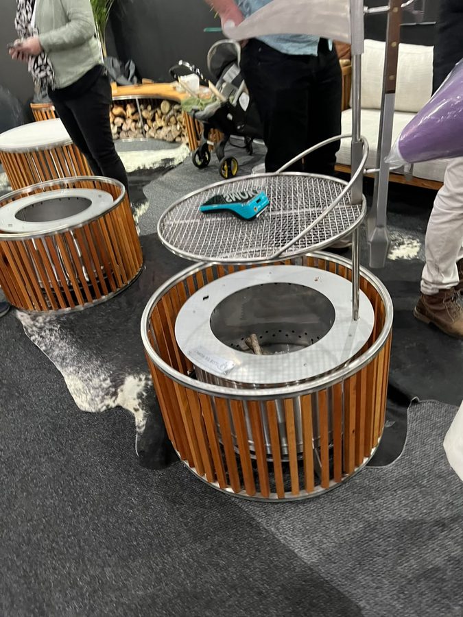 Fire pits made from vertical timber slats wrapped around steel bowls